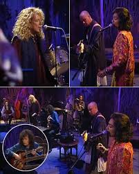 The Strings Whispered, the Voices Summoned — “The Battle of Evermore” Rises Again as Page & Plant Join Forces with Najma Akhtar in a Spellbinding, Otherworldly Ritual. This wasn’t a performance. It was a prophecy. Jimmy Page’s mandolin carved through silence like silver through smoke, while Robert Plant’s voice — part warrior, part seer — conjured the end of empires. Then came Najma Akhtar — ethereal, terrifyingly beautiful — weaving ancient Eastern lament into Zeppelin’s mythos. The result? Transcendental. Time-stopping. Almost dangerous…